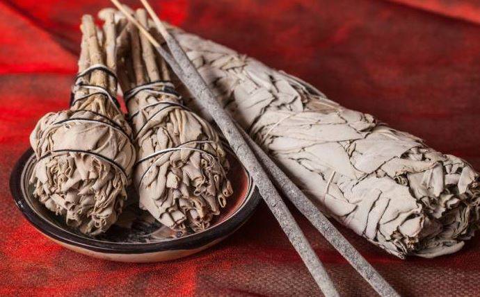 white sage incense on red background